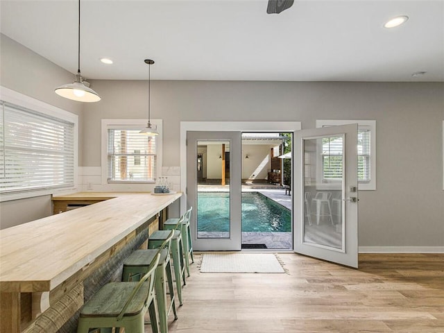 dining area with recessed lighting, wood finished floors, and a wealth of natural light