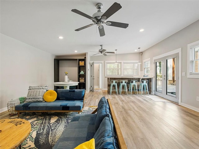 living area with baseboards, recessed lighting, and wood finished floors