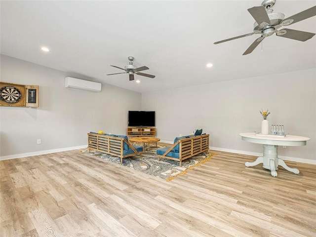 living area with ceiling fan, a wall mounted AC, wood finished floors, baseboards, and recessed lighting