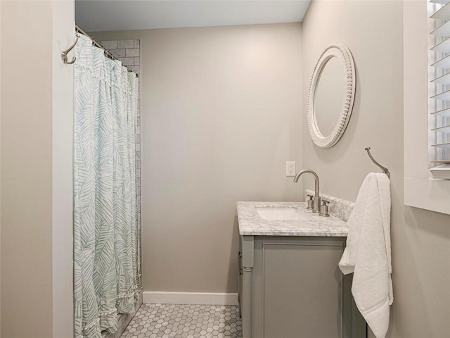 bathroom with baseboards, a shower with shower curtain, tile patterned flooring, and vanity