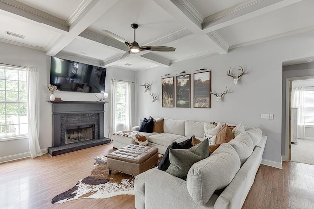 1751 Fire Side Ct, Jefferson, GA 30549 - living room featuring ceiling fan, healthy amount of natural light, a brick fireplace, beamed ceiling, and wood finished floors