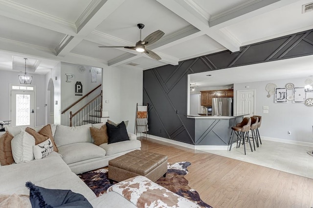 1751 Fire Side Ct, Jefferson, GA 30549 - living area featuring coffered ceiling, ceiling fan, arched walkways, light wood-style floors, and stairs