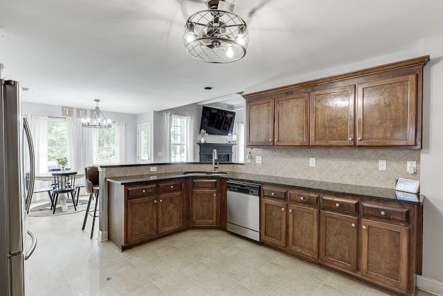 1751 Fire Side Ct, Jefferson, GA 30549 - kitchen featuring appliances with stainless steel finishes, a chandelier, a peninsula, and backsplash