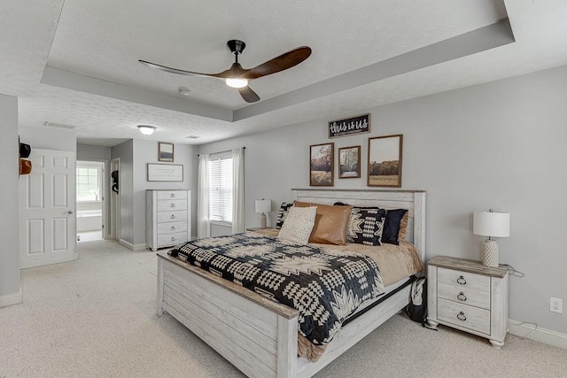 1751 Fire Side Ct, Jefferson, GA 30549 - bedroom featuring a tray ceiling, light colored carpet, a textured ceiling, and a ceiling fan