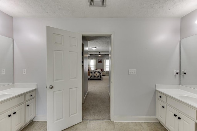 1751 Fire Side Ct, Jefferson, GA 30549 - bathroom with a textured ceiling and two vanities
