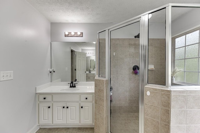 1751 Fire Side Ct, Jefferson, GA 30549 - bathroom featuring vanity, a stall shower, a textured ceiling, and tile patterned floors