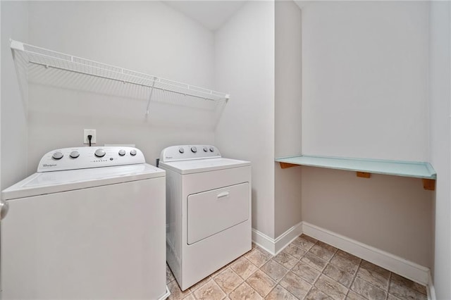 laundry room with baseboards, laundry area, and washer and dryer