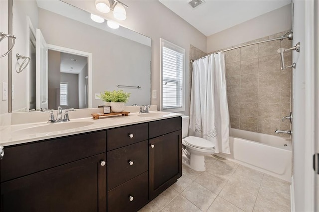 full bath with toilet, a sink, visible vents, and tile patterned floors