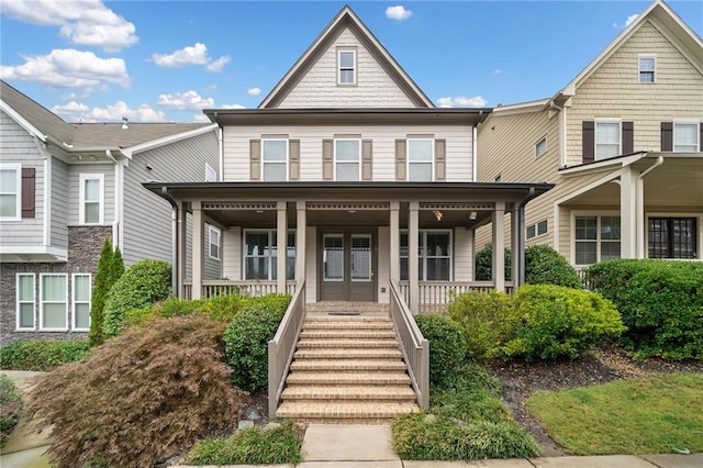 townhome / multi-family property with a porch, french doors, and stairs