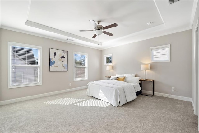 bedroom with light carpet, visible vents, baseboards, and a raised ceiling