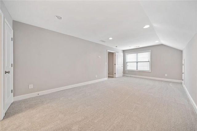 interior space featuring vaulted ceiling, recessed lighting, light colored carpet, and baseboards