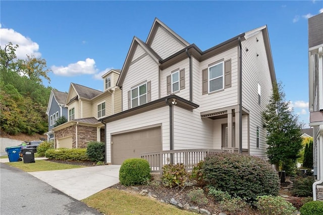 view of front of property featuring concrete driveway and an attached garage