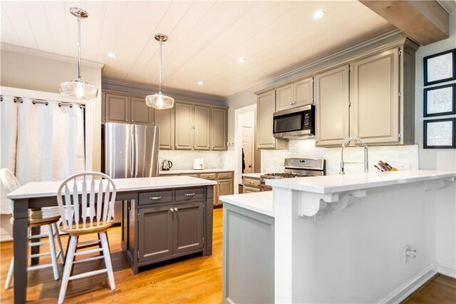 404 Summerchase Way, Woodstock, GA 30189 - kitchen with appliances with stainless steel finishes, gray cabinetry, light wood finished floors, light countertops, and a peninsula
