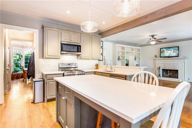 404 Summerchase Way, Woodstock, GA 30189 - kitchen featuring stainless steel appliances, gray cabinetry, a sink, light wood-style flooring, and beamed ceiling