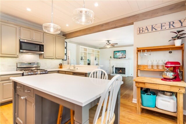 404 Summerchase Way, Woodstock, GA 30189 - kitchen with appliances with stainless steel finishes, a sink, light wood-type flooring, crown molding, and light countertops