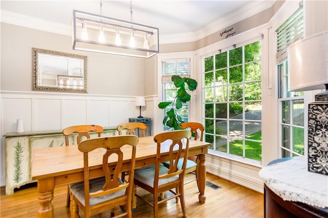 404 Summerchase Way, Woodstock, GA 30189 - dining space featuring a decorative wall, healthy amount of natural light, ornamental molding, light wood-type flooring, and a wainscoted wall