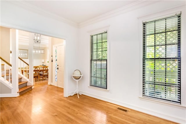404 Summerchase Way, Woodstock, GA 30189 - unfurnished room with wood finished floors, stairway, crown molding, a chandelier, and baseboards