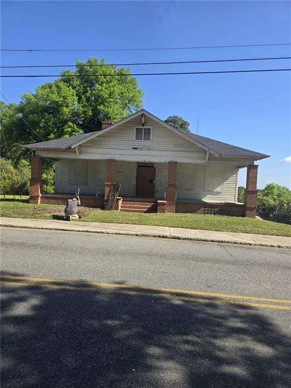 2279 Clayton St, Macon, GA 31204 - bungalow-style house with covered porch and brick siding
