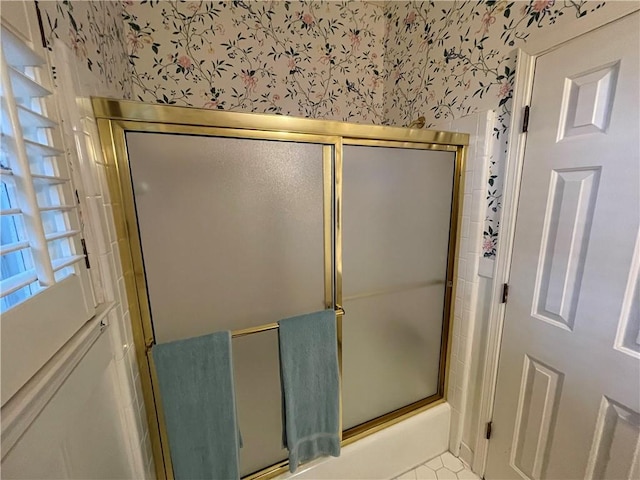 bathroom featuring a shower with door