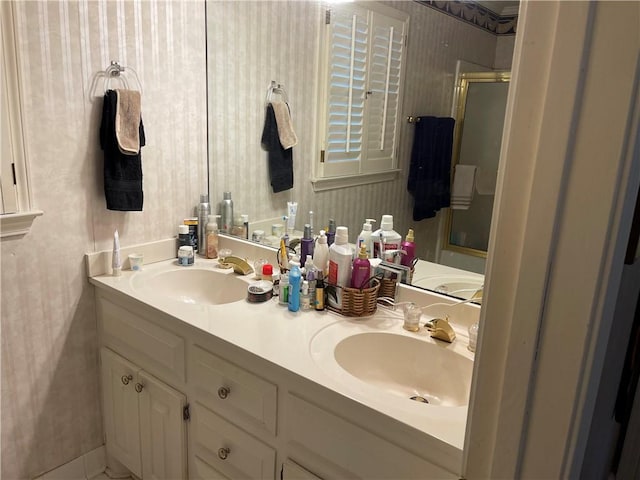 bathroom with vanity and a shower with door