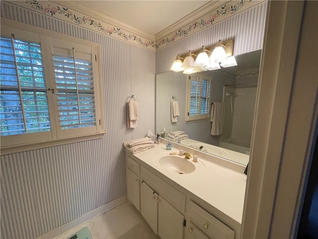 bathroom featuring vanity, crown molding, and tile patterned flooring