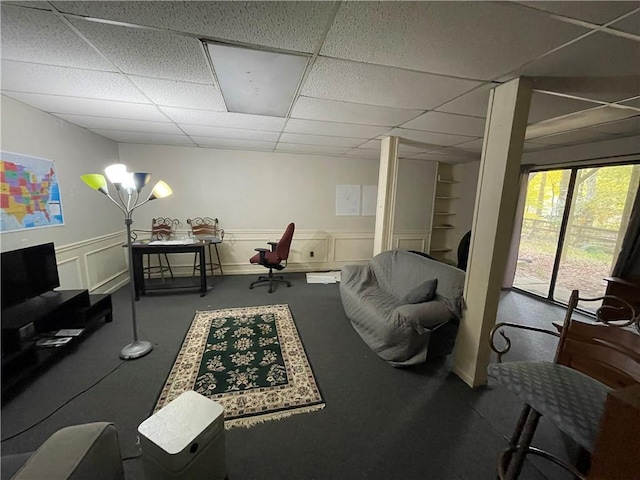 living room with a paneled ceiling