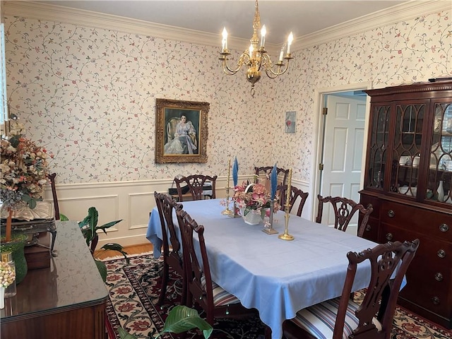 dining room with an inviting chandelier, crown molding, and wood-type flooring