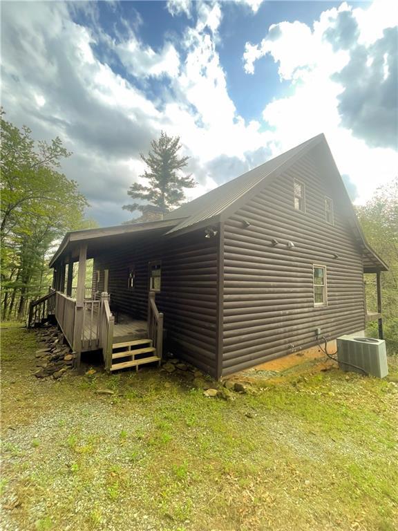 8072 Doublehead Gap Rd, Blue Ridge, GA 30513 - view of home's exterior with a chimney, a deck, and french doors