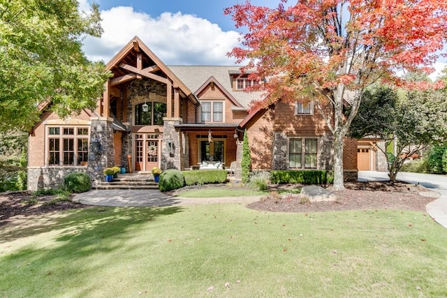 view of front of house featuring a garage and a front lawn