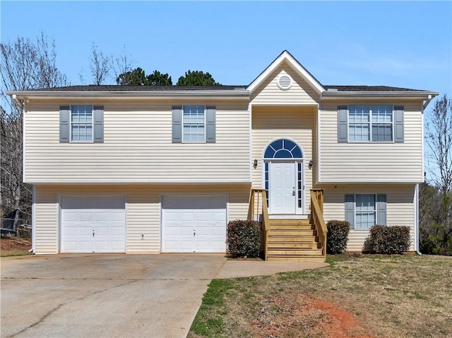 bi-level home with a garage and concrete driveway