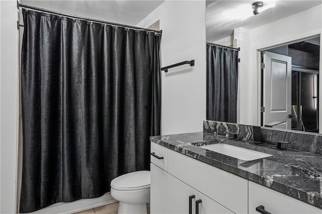 bathroom featuring curtained shower, vanity, toilet, and tile patterned floors