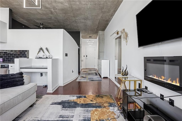 living room with a glass covered fireplace and wood finished floors