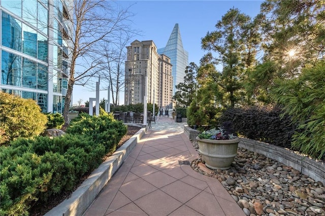 surrounding community featuring a view of city and a patio