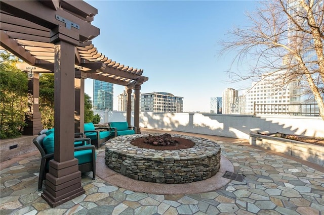 view of patio featuring a view of city, a fire pit, fence, and a pergola