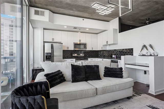 living room with dark wood-style flooring and visible vents