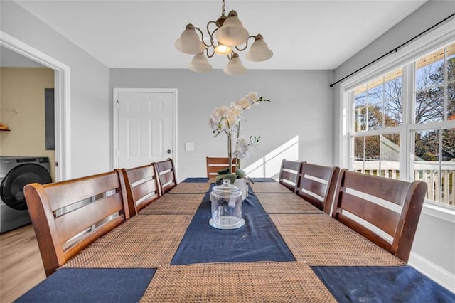 276 Arbor Gate Dr, Cornelia, GA 30531 - dining room with washer / clothes dryer, a chandelier, and wood finished floors