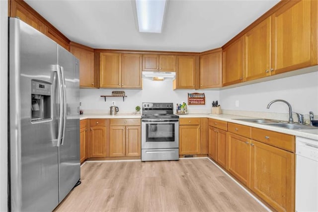 276 Arbor Gate Dr, Cornelia, GA 30531 - kitchen featuring stainless steel appliances, under cabinet range hood, light wood-style flooring, light countertops, and brown cabinets