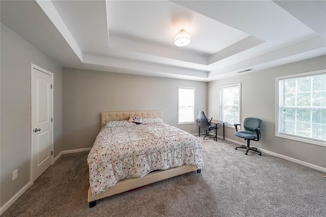bedroom featuring a raised ceiling, baseboards, carpet flooring, and visible vents