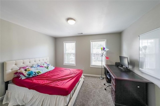 carpeted bedroom featuring baseboards