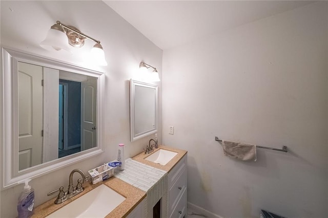 bathroom featuring a sink, baseboards, and double vanity