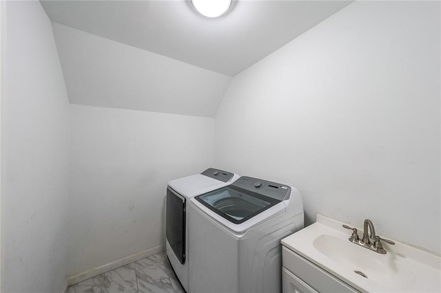 laundry area with laundry area, washing machine and clothes dryer, a sink, baseboards, and marble finish floor