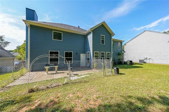 rear view of property featuring fence, a patio, a chimney, central AC unit, and a lawn