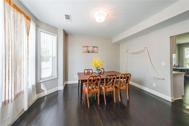 dining area featuring visible vents, dark wood-style flooring, baseboards, and a healthy amount of sunlight