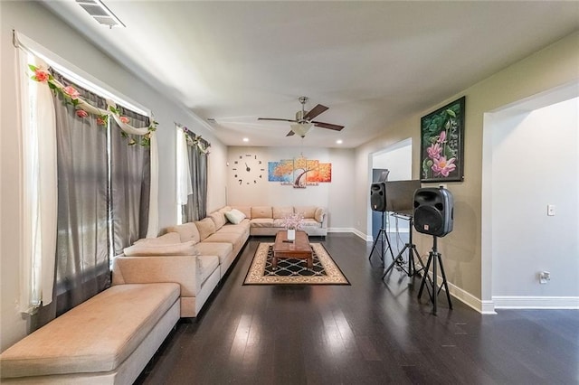 living room featuring baseboards, a ceiling fan, and wood finished floors