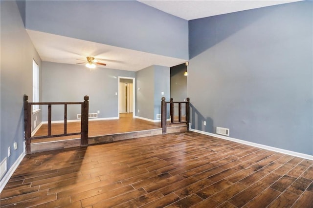 empty room featuring ceiling fan and dark hardwood / wood-style flooring