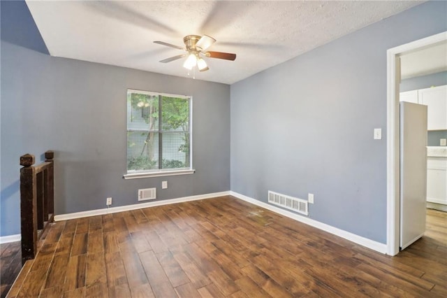 unfurnished room with ceiling fan, dark hardwood / wood-style floors, and a textured ceiling