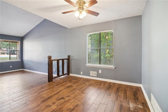 spare room with lofted ceiling, dark hardwood / wood-style floors, and ceiling fan