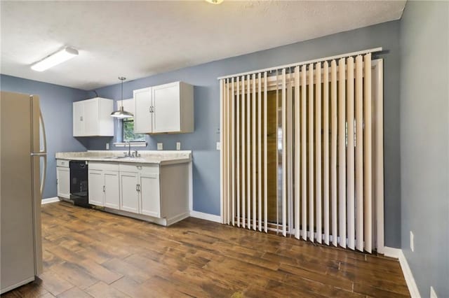 kitchen with white cabinetry, black dishwasher, sink, hanging light fixtures, and white refrigerator