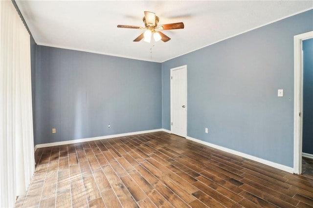 empty room with ceiling fan and dark hardwood / wood-style flooring