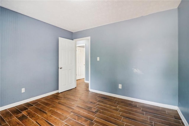 empty room with dark wood-type flooring